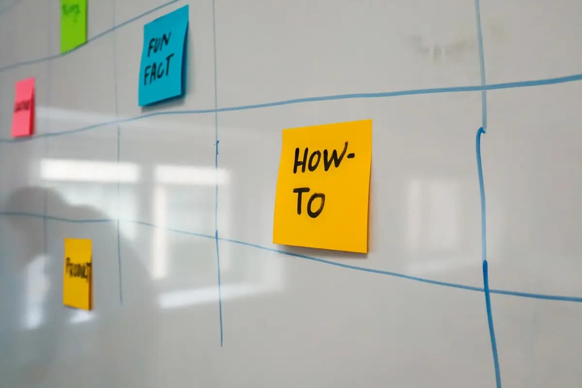 Organized whiteboard with colorful sticky notes used for planning and brainstorming.