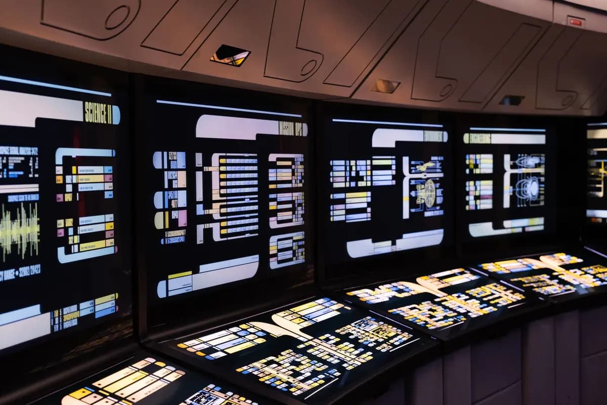 A high-tech command center with illuminated digital screens in a futuristic setting.